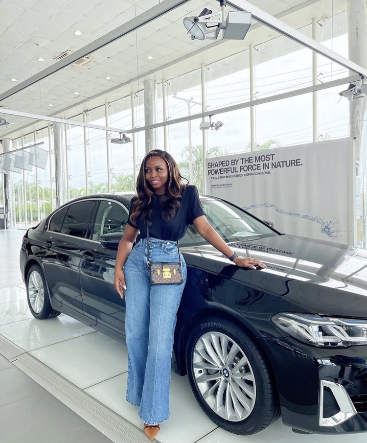 Sandrah standing next to the BMW 5 series