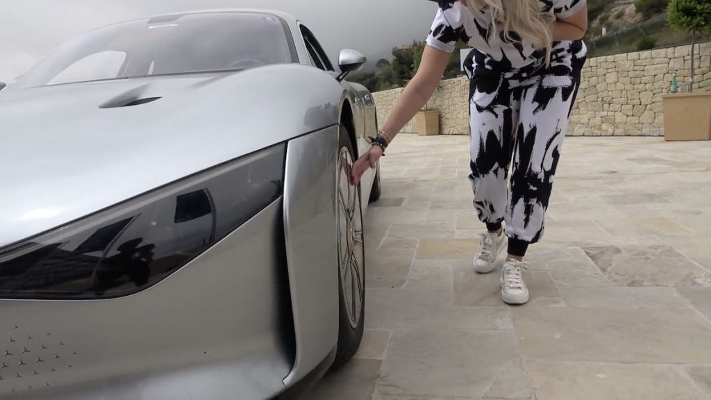 Super car blondie touching Mercedes EQXX