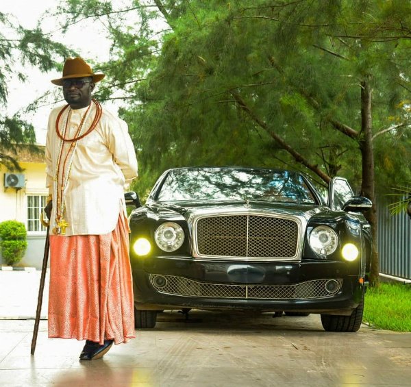 Chief Ayiri Posing In Front Of His Car