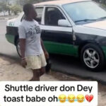 Taxi driver spotted toasting a Babe while on the move